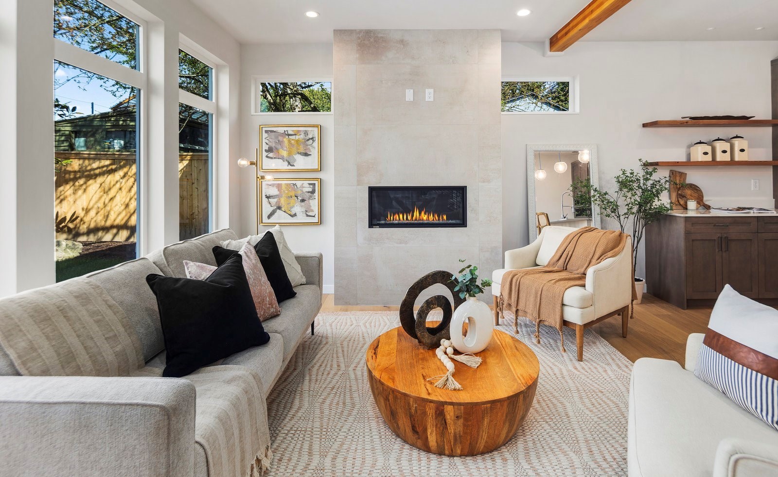 Staged living room with fireplace in a new construction Kirkland home by IntExt Staging