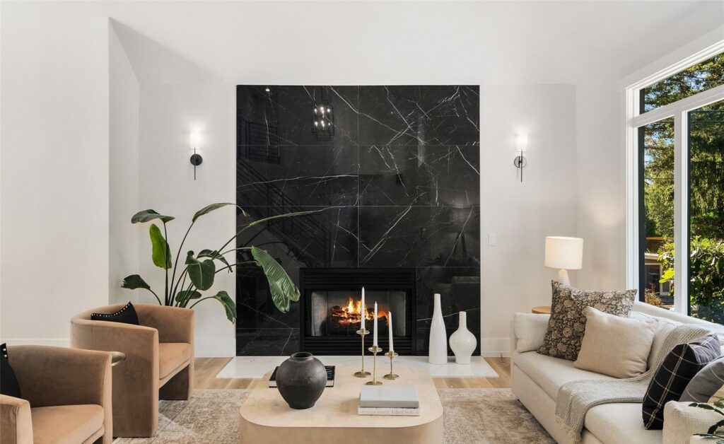 Newcastle home staging in a luxury living room with a black marble fireplace, curved chairs and a sofa