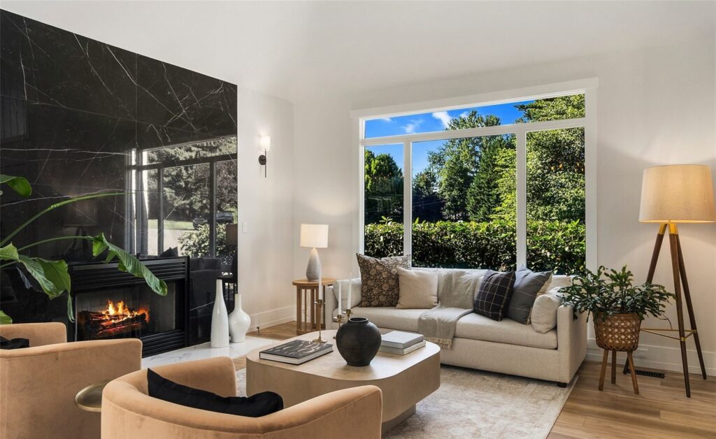 Living room seating beside a large garden window and floor lamp