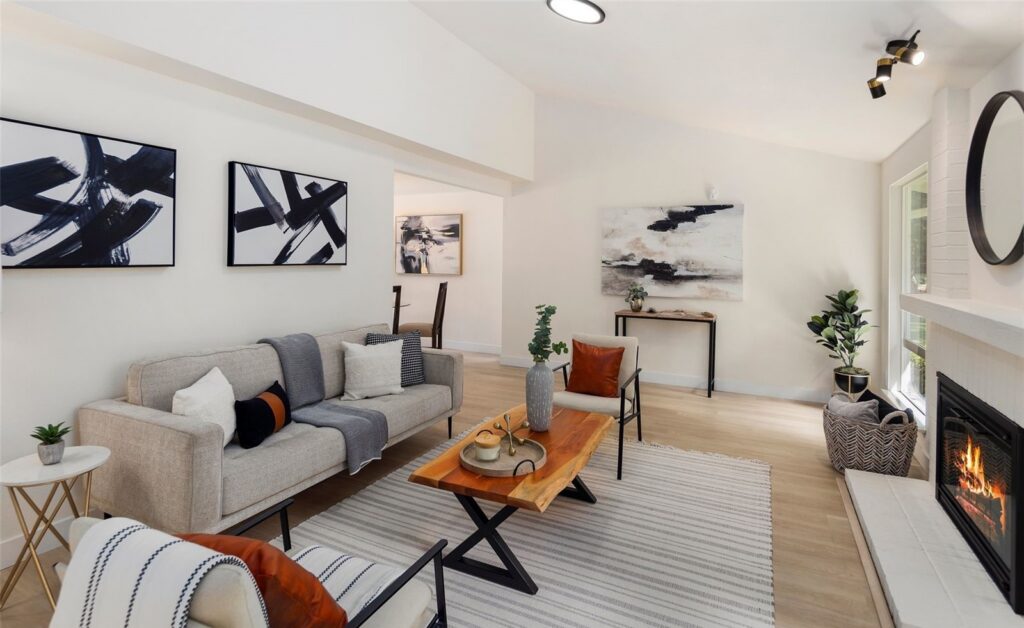 Sammamish home staging in a light-filled living room with a gray sofa, accent pillows and abstract art