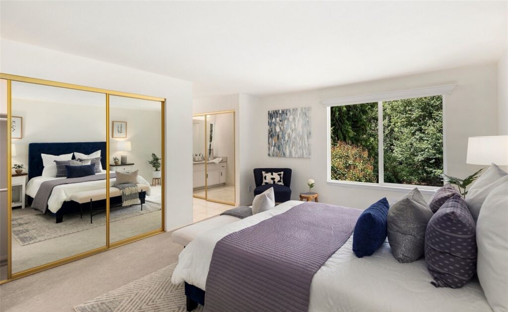Primary bedroom with a navy upholstered headboard and layered bedding